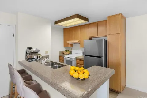a kitchen with a table chairs and a refrigerator