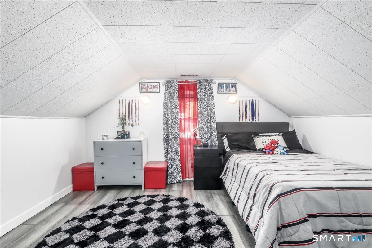 306 Welton Street Hamden, CT 06517 - Photo 22 of 38 a bedroom with a bed and window