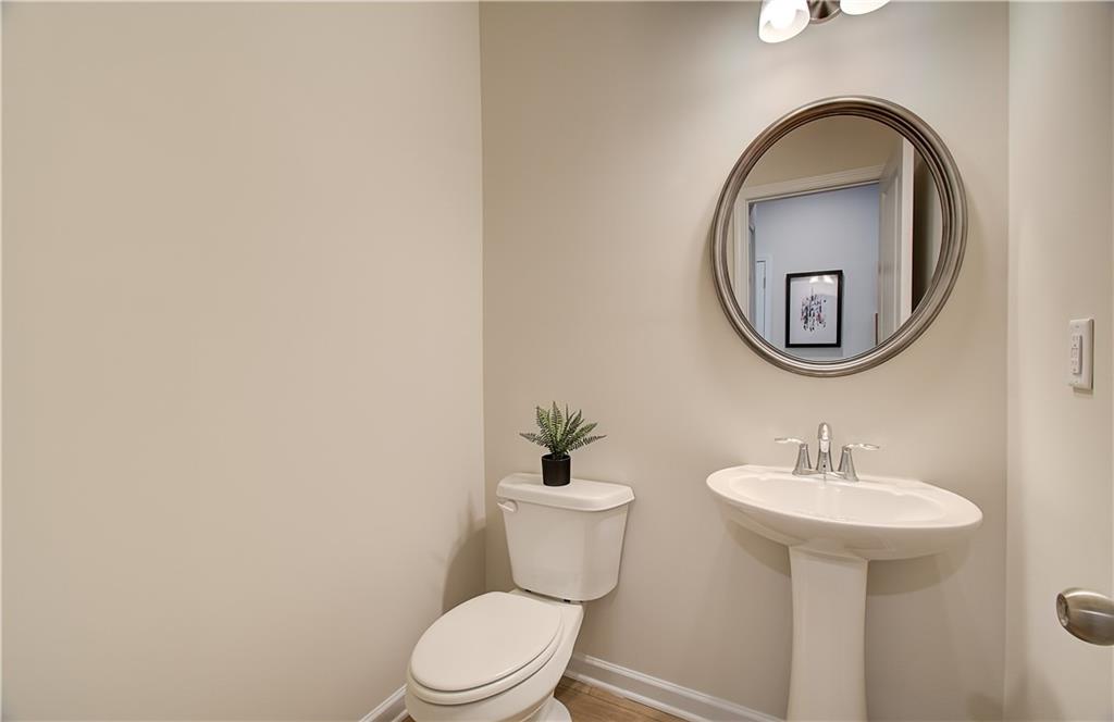 4581 Ajo Walk Atlanta, GA 30331 - Photo 13 of 19 a bathroom with a toilet sink and mirror