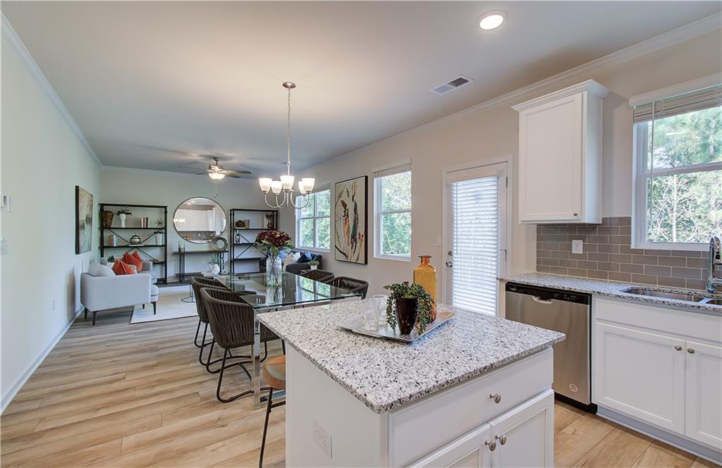 4581 Ajo Walk Atlanta, GA 30331 - Photo 10 of 19 a kitchen with a table chairs and wooden floor