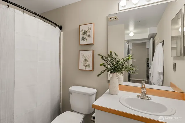 a bathroom with a sink toilet and mirror