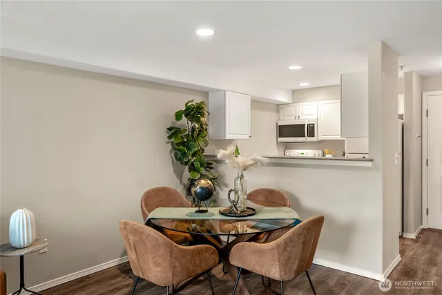 a dining room with furniture and wooden floor