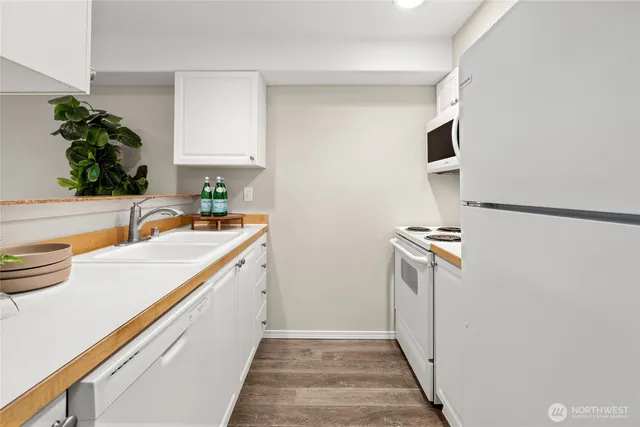 a kitchen with a sink and a refrigerator