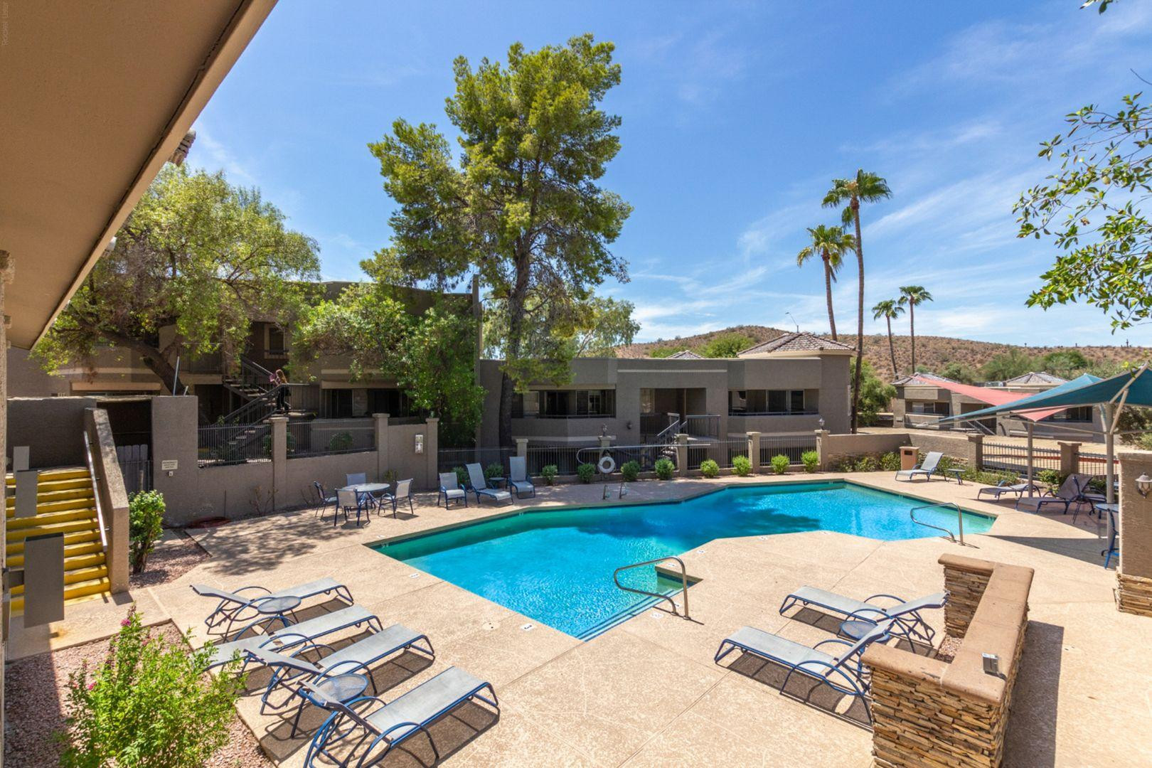 1720 East Thunderbird Road, Unit 1086 Phoenix, AZ 85022 - Photo 28 of 32 a view of a backyard with couches potted plants and a large tree
