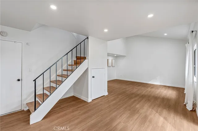 a bedroom with a bed and a potted plant