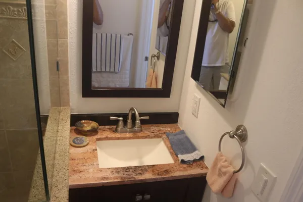 a bathroom with mirror sink and vanity