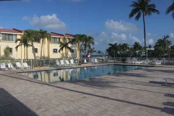 a view of swimming pool with a table and chairs