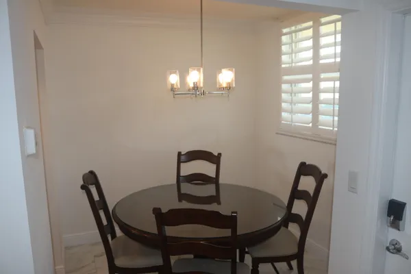 a view of a dining room with furniture and chandelier