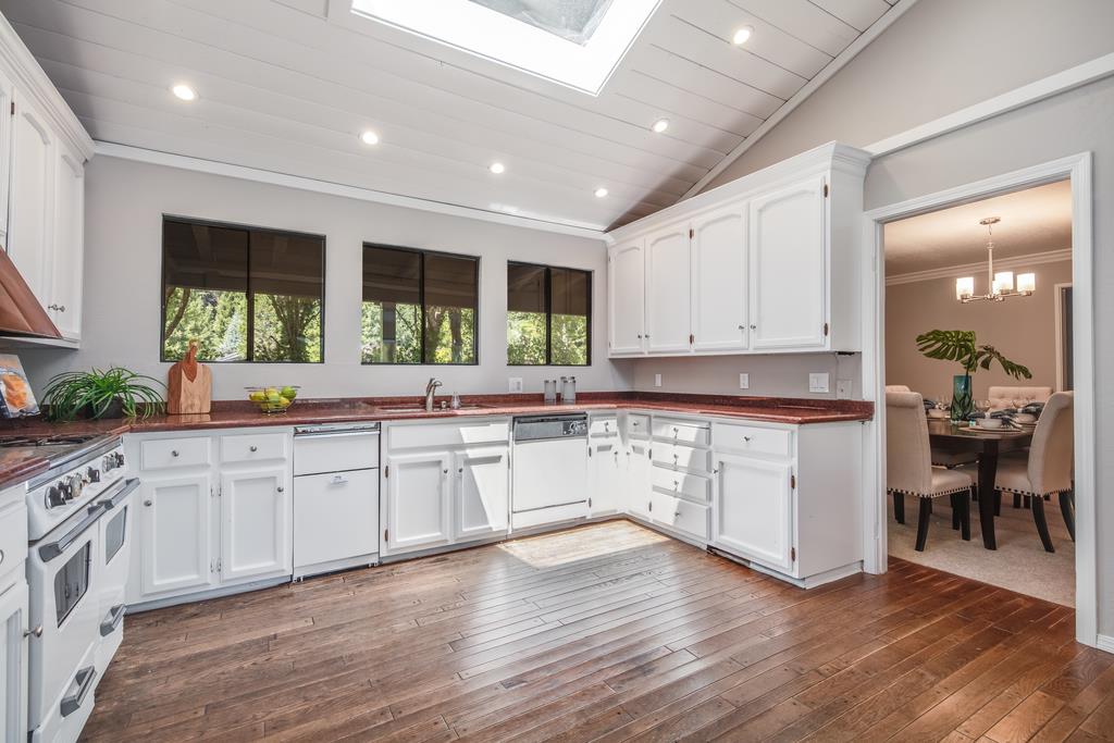 1975 Portola Road Woodside, CA 94062 - Photo 12 of 49 a large white kitchen with wooden floors and white stainless steel appliances