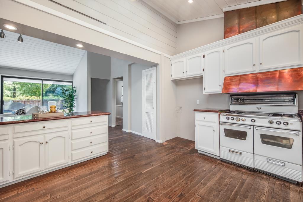 1975 Portola Road Woodside, CA 94062 - Photo 13 of 49 a kitchen with stainless steel appliances white cabinets and wooden floors