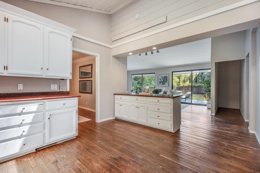 1975 Portola Road Woodside, CA 94062 - Photo 15 of 49 a kitchen with stainless steel appliances white cabinets and wooden floors