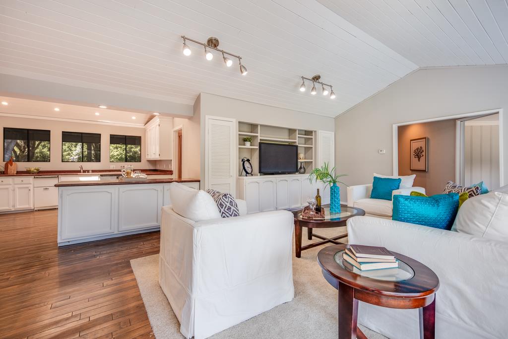 1975 Portola Road Woodside, CA 94062 - Photo 16 of 49 a living room with furniture a flat screen tv and kitchen view