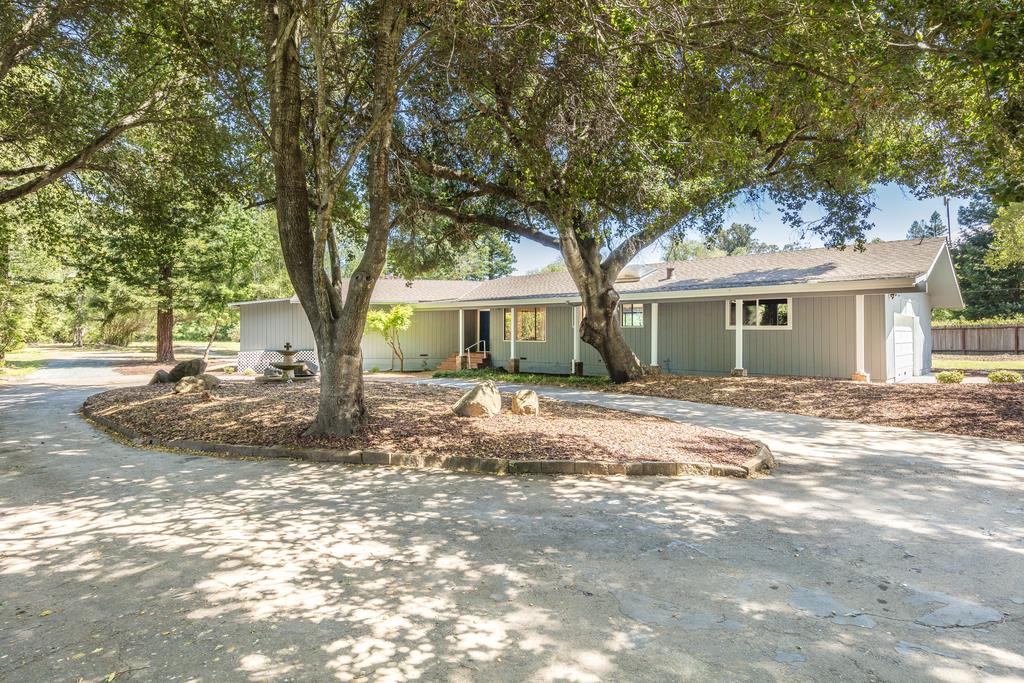 1975 Portola Road Woodside, CA 94062 - Photo 2 of 49 a view of a house with a tree in the yard