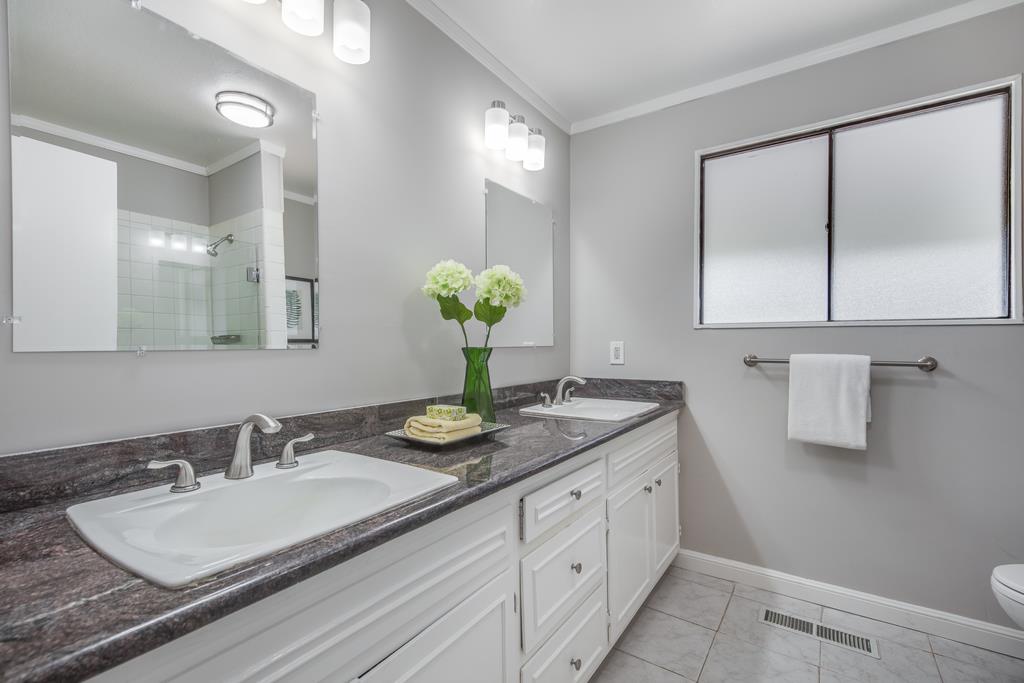 1975 Portola Road Woodside, CA 94062 - Photo 24 of 49 a bathroom with a granite countertop sink a mirror and a shower