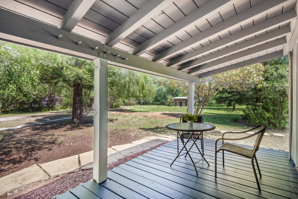 1975 Portola Road Woodside, CA 94062 - Photo 28 of 49 a view of a patio with chairs and wooden floor
