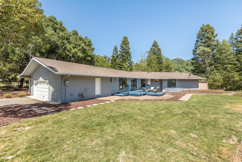 1975 Portola Road Woodside, CA 94062 - Photo 34 of 49 a front view of house with yard and trees in the background