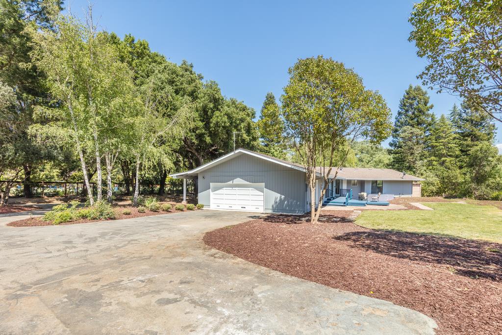 1975 Portola Road Woodside, CA 94062 - Photo 37 of 49 a front view of a house with a yard and garage
