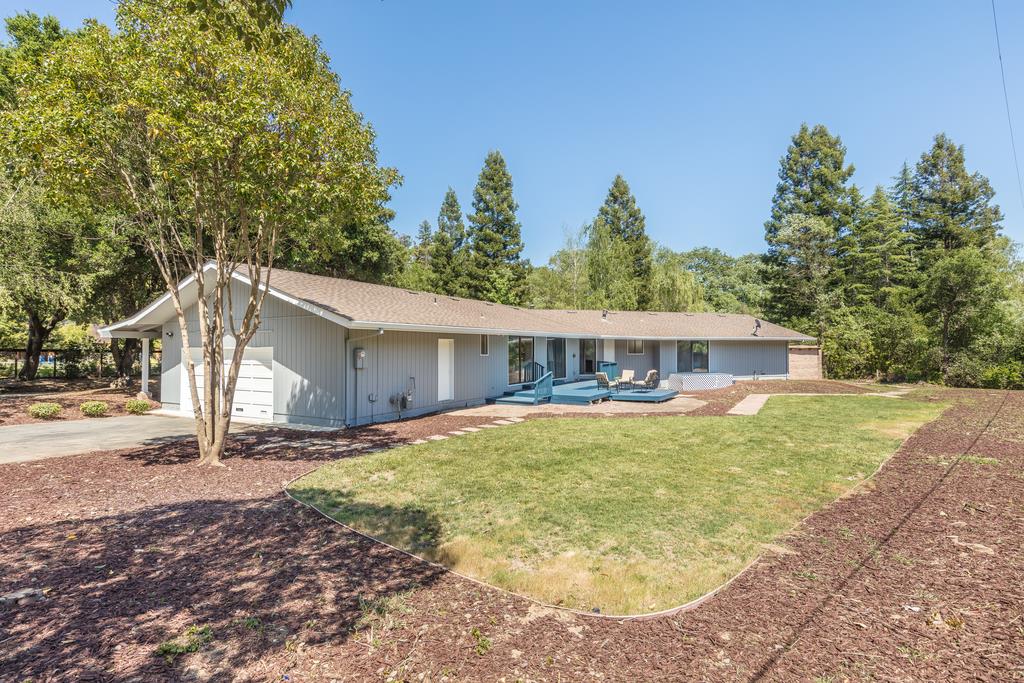 1975 Portola Road Woodside, CA 94062 - Photo 38 of 49 a front view of house with yard and trees in the background