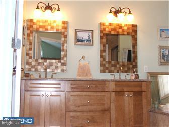 142 Wyndmoor Road Springfield, PA 19064 - Photo 6 of 12 a bathroom with a sink and a mirror