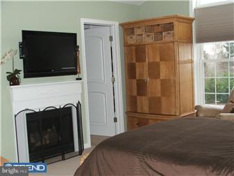 142 Wyndmoor Road Springfield, PA 19064 - Photo 7 of 12 a bedroom with a bed and a flat screen tv