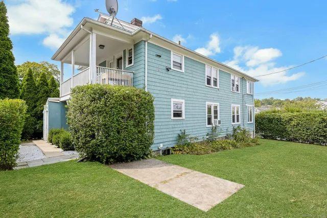 a front view of a house with a garden