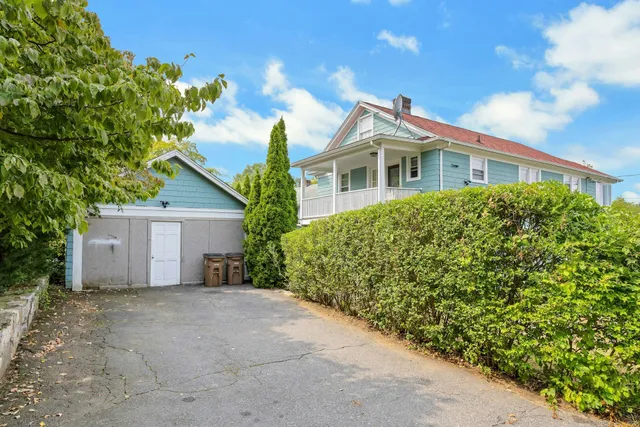 a front view of a house with a garden