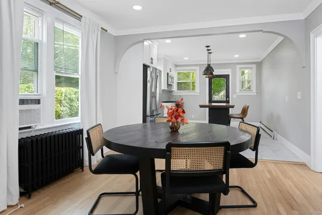 a dining room with furniture and window