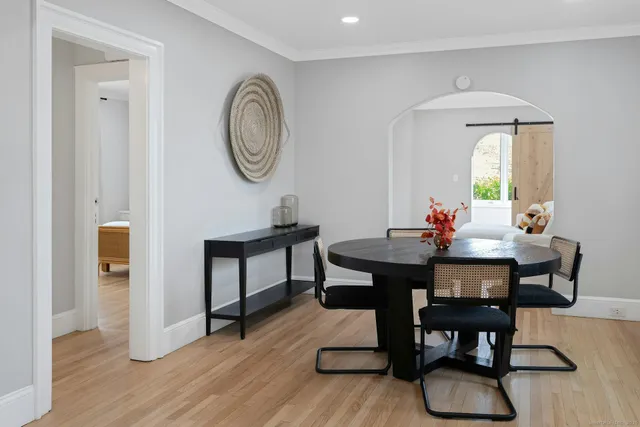 a view of a dining room with furniture and wooden floor