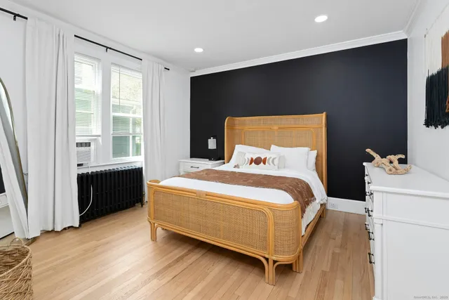 a bed room with a bed and a large window