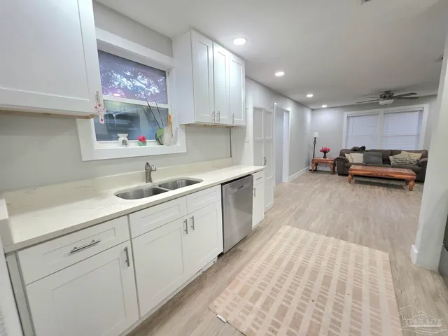 a kitchen with cabinets a sink and appliances