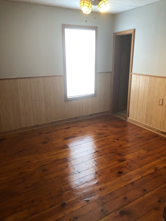 21 Whipple Street, Unit 3 Worcester, MA 01607 - Photo 3 of 8 an empty room with wooden floor and windows