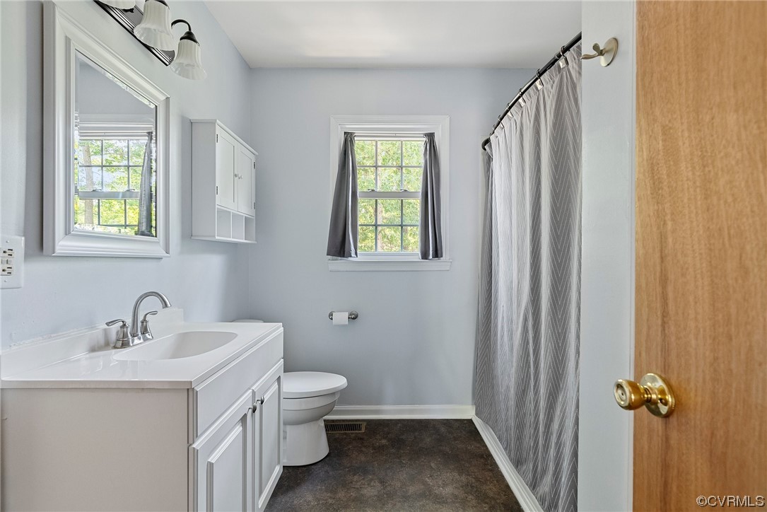 6501 Brambleton Road Chesterfield, VA 23832 - Photo 17 of 18 a bathroom with a sink a toilet and shower