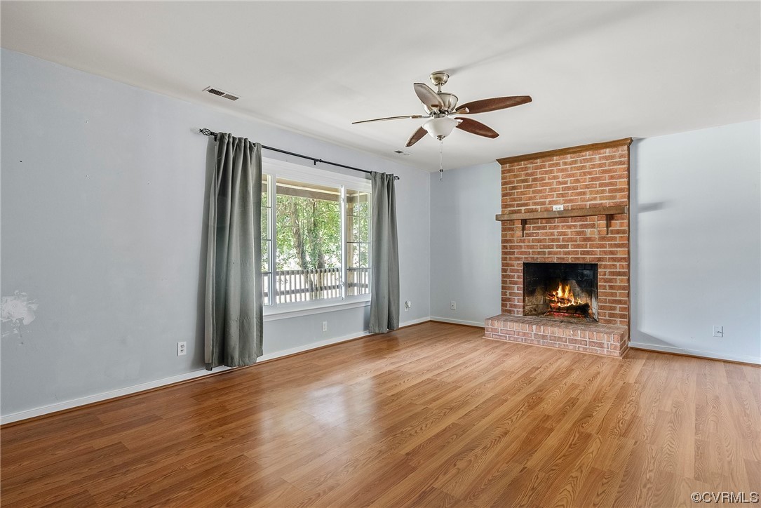 6501 Brambleton Road Chesterfield, VA 23832 - Photo 8 of 18 a view of an empty room with wooden floor fireplace and a window