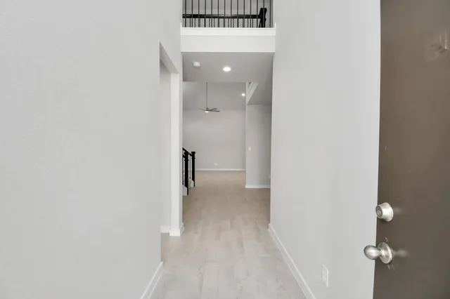 a view of a hallway with wooden floor