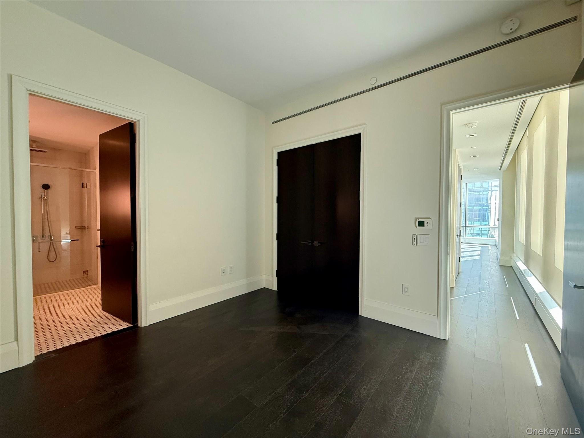 172 Madison Avenue, Unit 17C Manhattan, NY 10016 - Photo 21 of 27 an empty room with wooden floor and windows