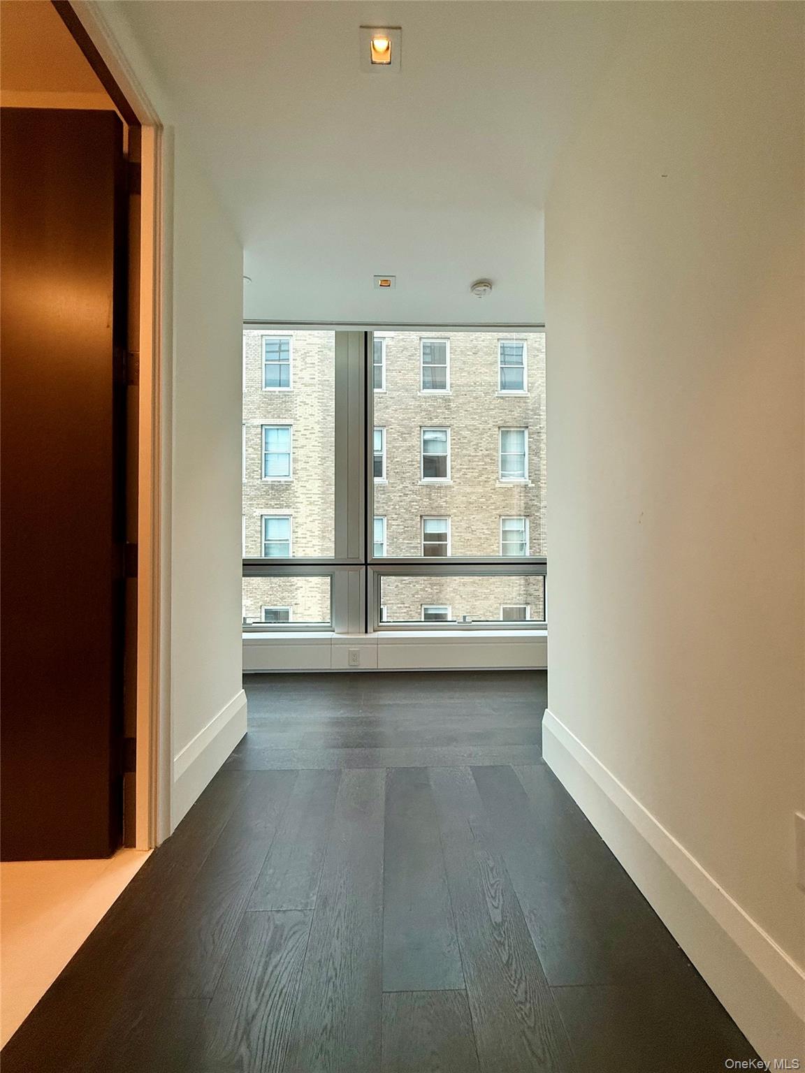 172 Madison Avenue, Unit 17C Manhattan, NY 10016 - Photo 8 of 27 a view of an empty room with a window
