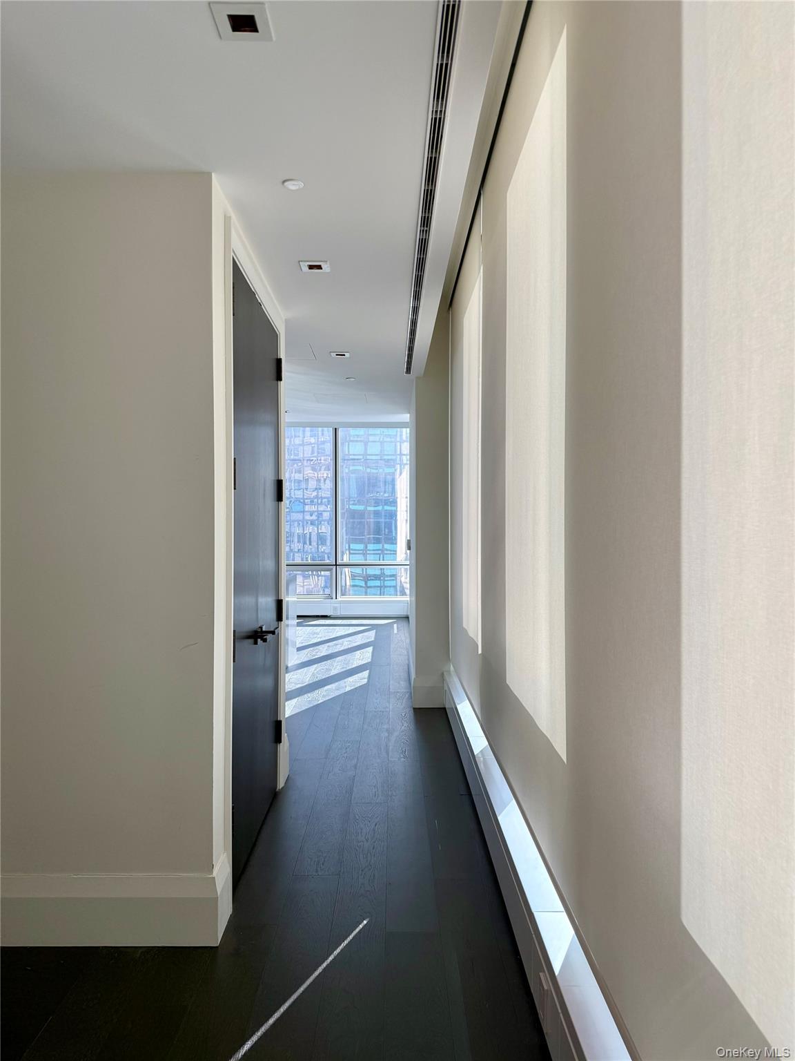172 Madison Avenue, Unit 17C Manhattan, NY 10016 - Photo 10 of 27 a view of a hallway with wooden floor
