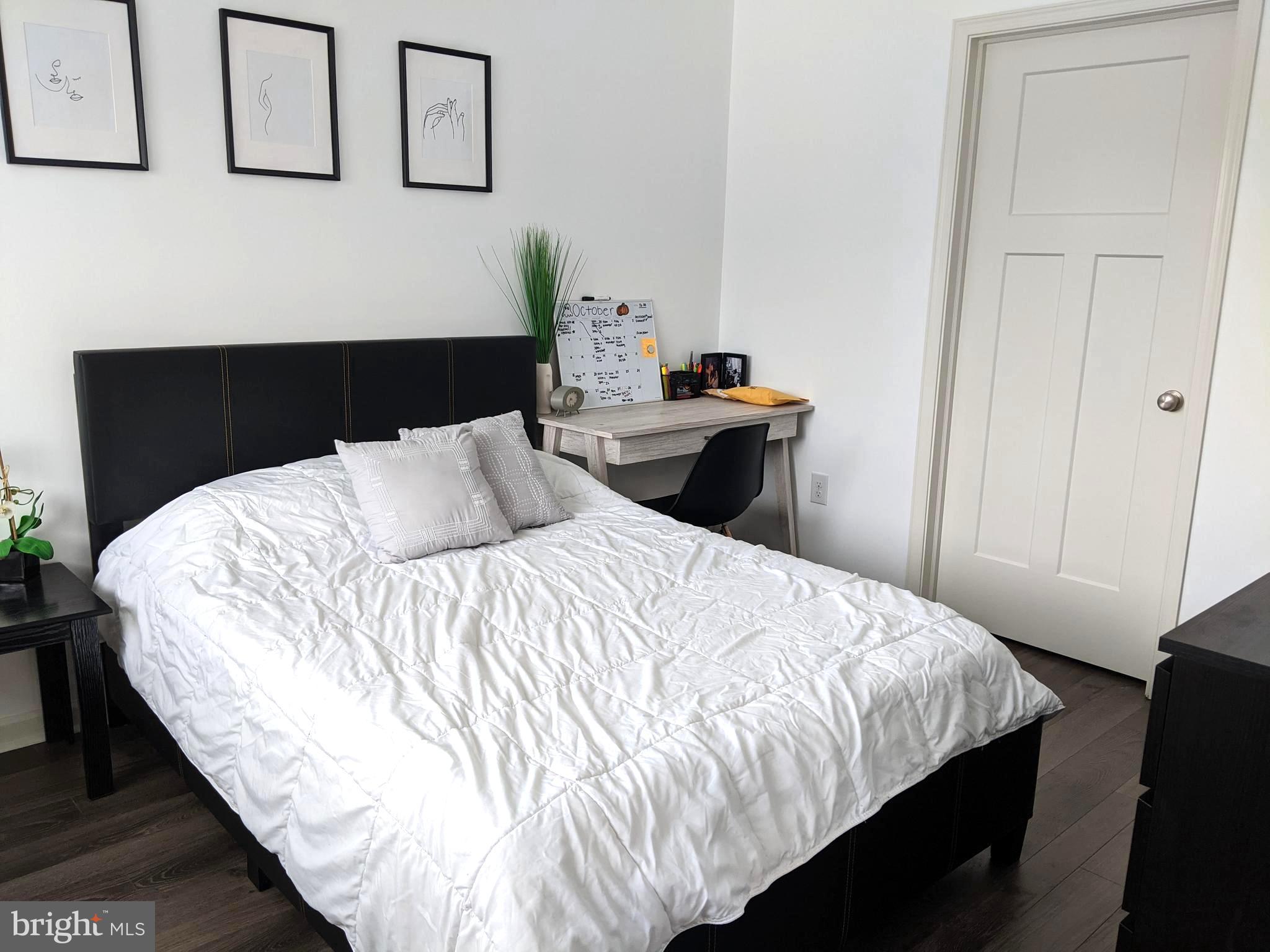 5420 Ridge Avenue, Unit 310 Philadelphia, PA 19128 - Photo 5 of 12 a bedroom with a bed and painting on the wall