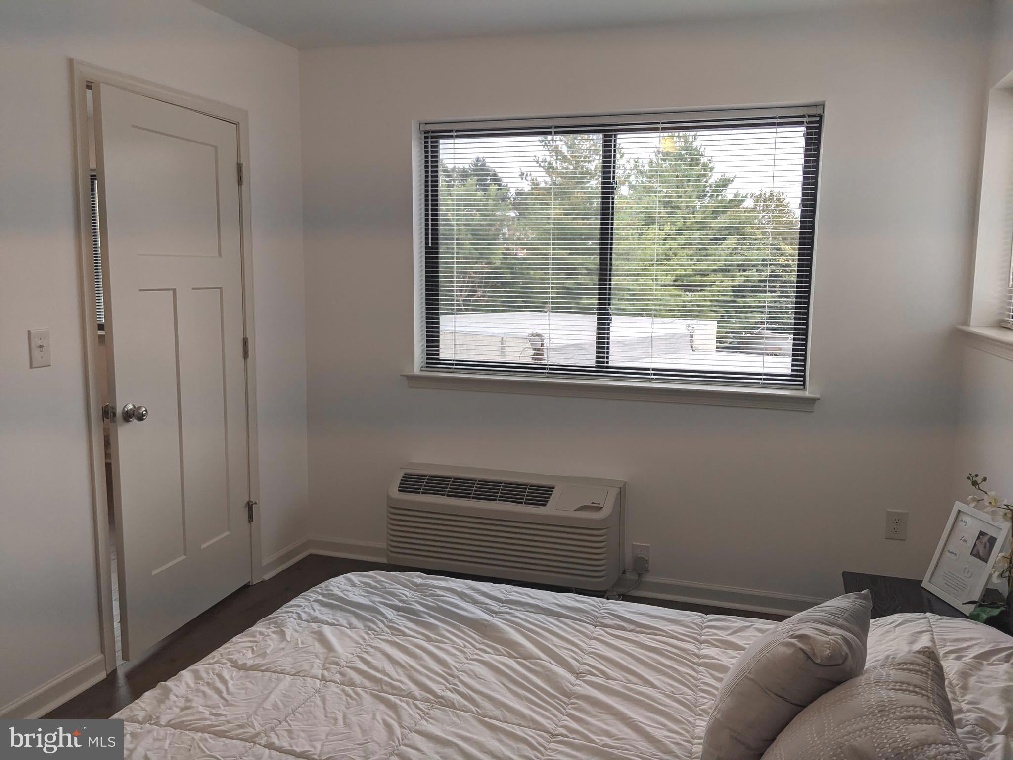5420 Ridge Avenue, Unit 310 Philadelphia, PA 19128 - Photo 6 of 12 a bedroom with a bed and a window