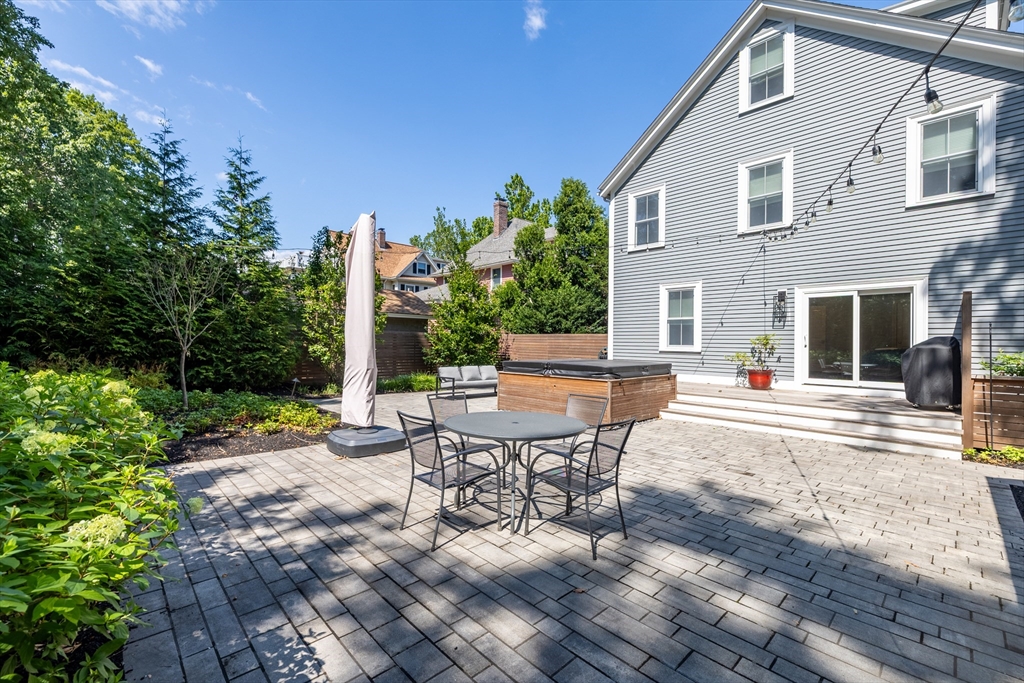 31 Bartlet Street Andover, MA 01810 - Photo 4 of 6 a view of a patio with table and chairs and potted plants