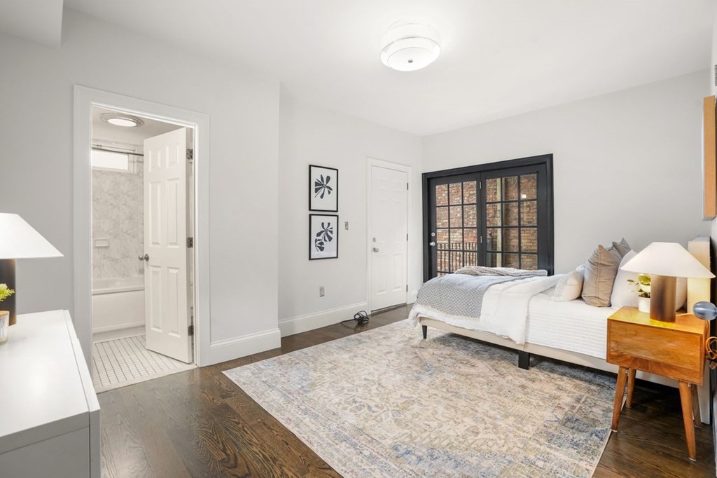 11 Union Street, Unit 2 Boston, MA 02129 - Photo 16 of 22 a spacious bedroom with a bed and a table in it