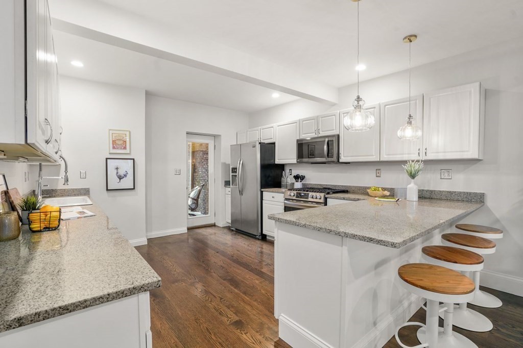 11 Union Street, Unit 2 Boston, MA 02129 - Photo 2 of 22 a kitchen with stainless steel appliances granite countertop a sink stove and refrigerator