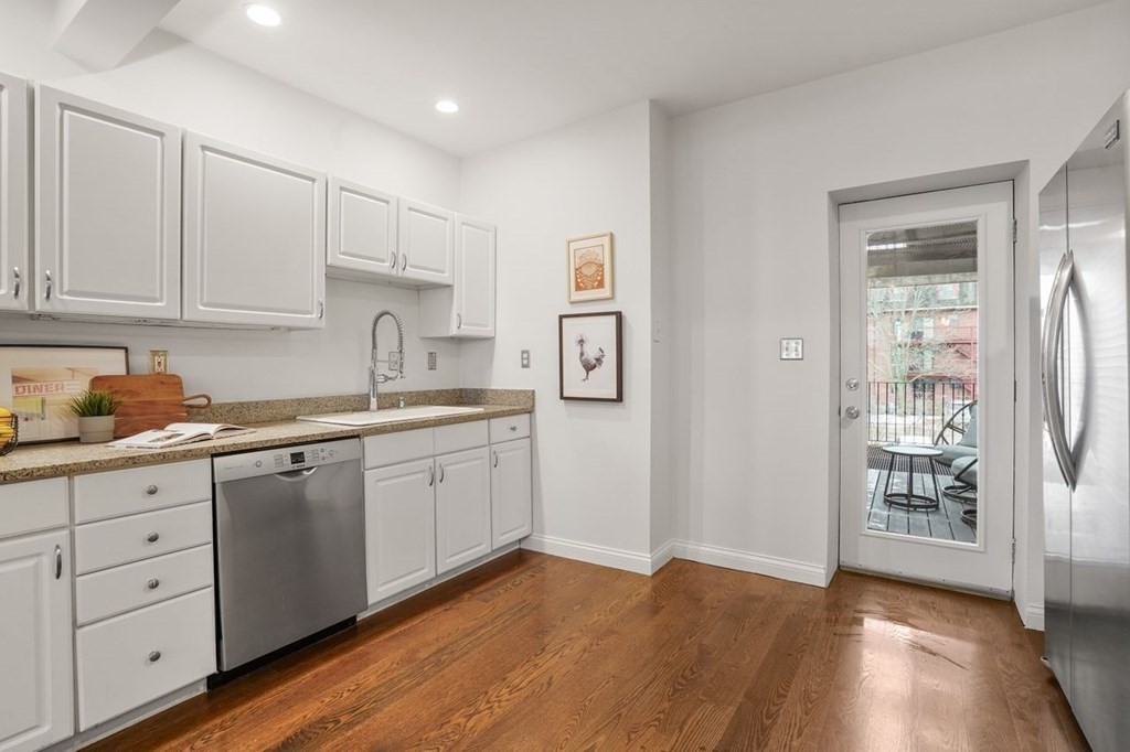 11 Union Street, Unit 2 Boston, MA 02129 - Photo 6 of 22 a kitchen with granite countertop white cabinets and white appliances