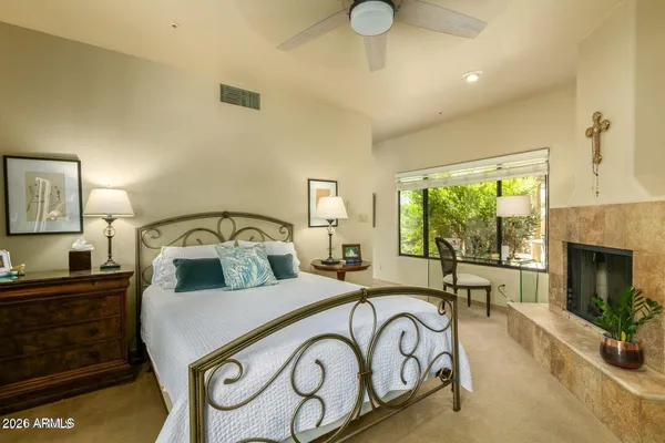 a bedroom with a bed and a fireplace