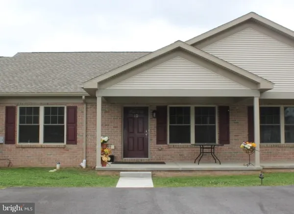 a front view of a house with a yard and tv