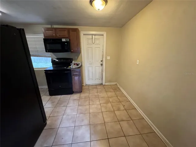 a hallway with a stove top oven a sink and dishwasher