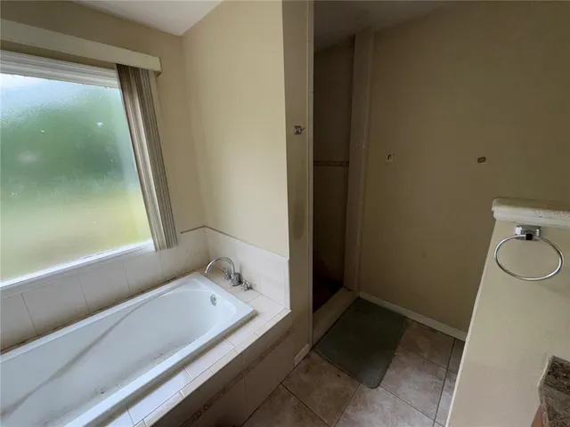 a bathroom with a bathtub and toilet
