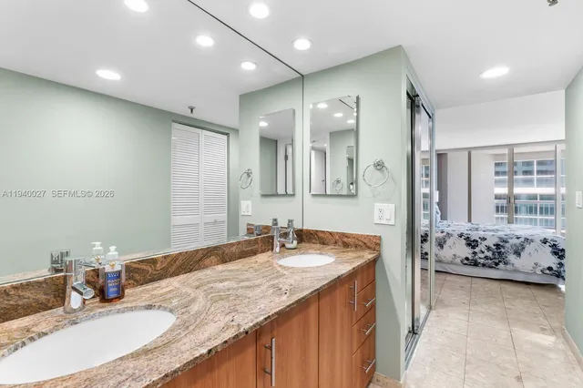 a bathroom with a granite countertop sink and a mirror
