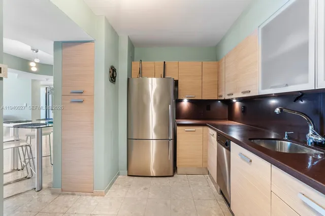 a kitchen with stainless steel appliances a refrigerator and a sink