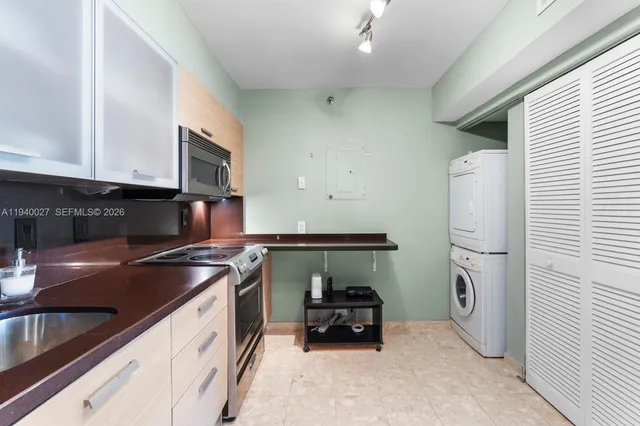 a kitchen with a sink and a stove top oven